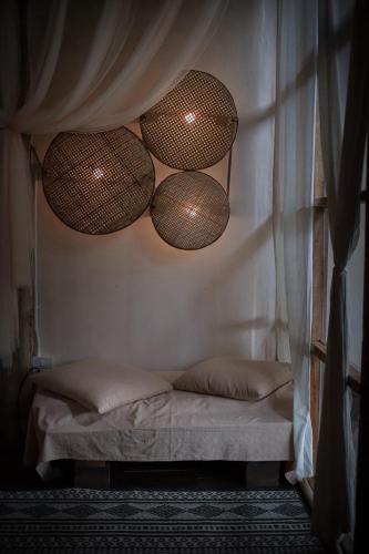 a bedroom with a bed with nets on the wall at Chi Bo ดอยช้าง in Ban Huai Khai