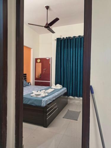 a bedroom with a bed and a ceiling fan at The Global Nest Homestay 