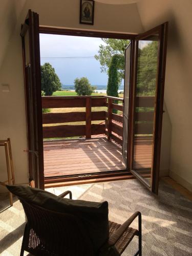 a sliding glass door leading to a deck with a fence at Ku Wiśle 