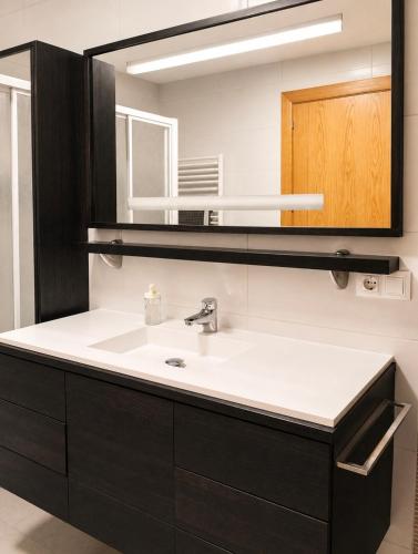 a bathroom with a sink and a mirror at Conde de Lerín by Clabao in Lerín