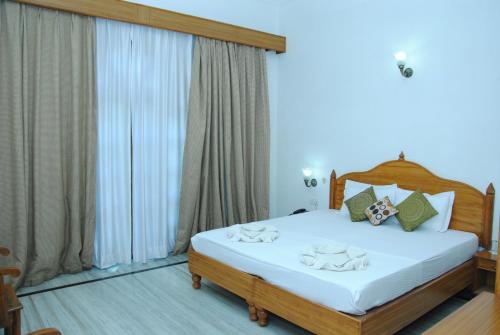 a bedroom with a bed with towels on it at Hotel isabel Palace in Khajurāho