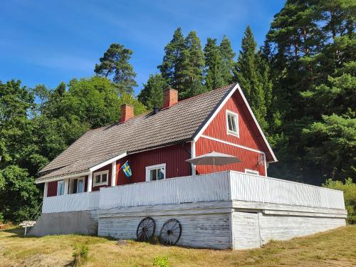 a red barn sitting on top of a field at StayinDalsland in Dals Långed