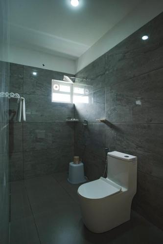 a bathroom with a toilet and a shower at Grace Residency in Sultan Bathery