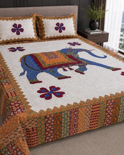 a bed with a quilt with a horse on it at Hotel teara in Gwalior