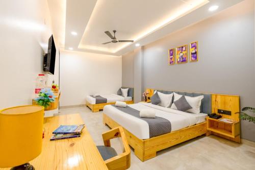 a bedroom with a bed and a tv in it at Hotel teara in Gwalior