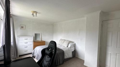 a bedroom with a bed and a desk and a chair at Koti in Murton