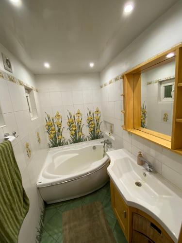 a bathroom with a tub and a sink at House By The Sea With Hot Tub in Riga