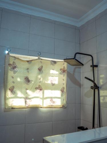 a towel hanging on a wall in a bathroom at Nam's Homestay in Arusha