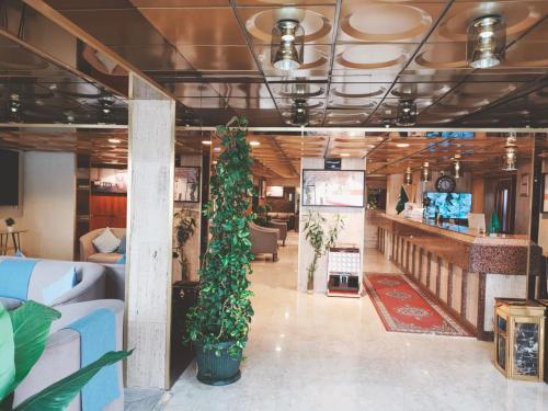 a lobby with a christmas tree in the middle at فندق هدب - المربع in Riyadh