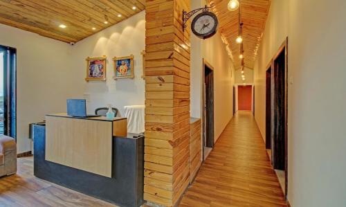 a hallway with a clock on a wall at Green Woods Cottage by JN in Mahabaleshwar