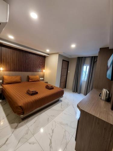a bedroom with a large bed in a room at Sitara Patong Beach in Patong Beach