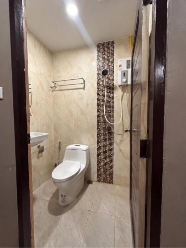 a bathroom with a toilet and a shower at Sitara Patong Beach in Patong Beach