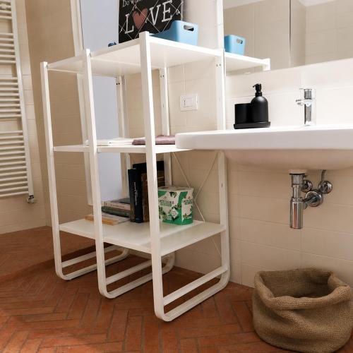 a white shelf under a sink in a bathroom at La Casa dei Turchi in Rovereto