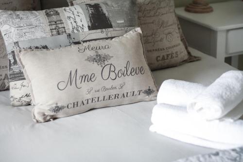 a bed with a pillow that saysmine bellele for the coach of daughters at Olive Manor Guest House in Newcastle
