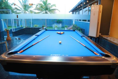 a pool table in a room with a pool at The Park Lane Hotel in Krishnagiri
