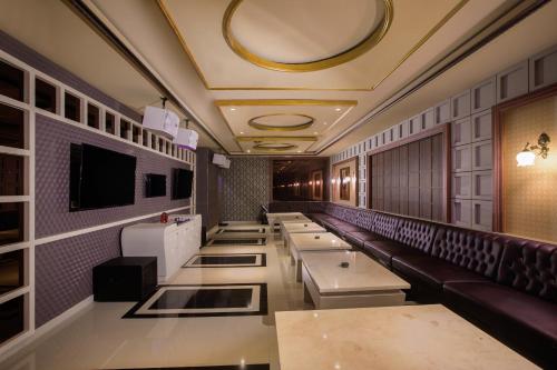 a restaurant with a row of tables in a room at Hotel Chanti Managed by TENTREM Hotel Management Indonesia in Semarang