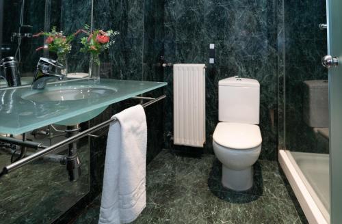 a bathroom with a toilet and a sink at Hotel Ciutat Martorell in Martorell