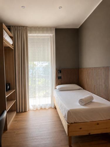 a bedroom with a bed and a large window at Residenza Ricci in Azzano San Paolo