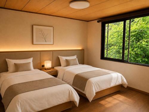 two beds sitting in a room with a window at LUX Niseko lodge in Niseko
