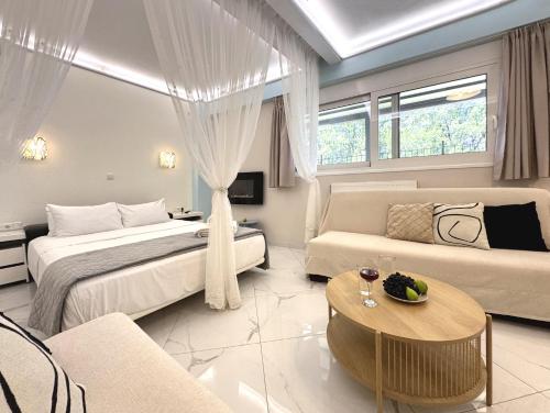 a hotel room with two beds and a couch at SEMIRAMIS SUITES with pool in Kalamata