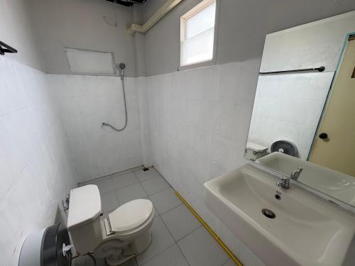a bathroom with a toilet and a sink and a mirror at Like A Friend Hostel in Thong Sala