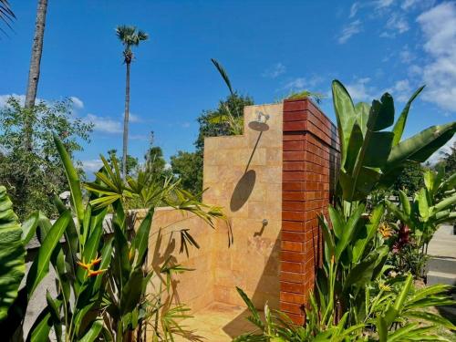 a clock on the side of a brick wall at Atta Residence by Manara in Seraya