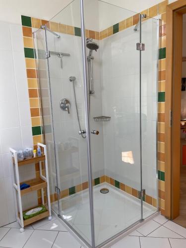 a shower with a glass door in a bathroom at Villa "Auszeit" in Hohen Neuendorf