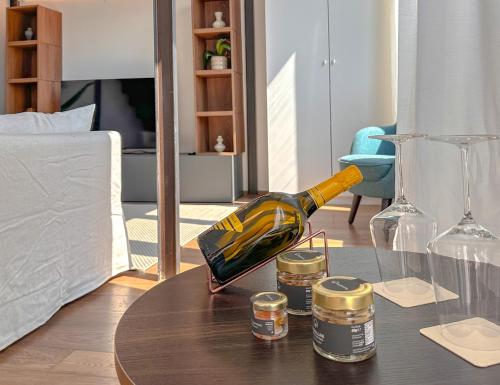 a bottle of wine on a table in a living room at FLATSHARING - SPADARI Duomo Suites in Milan