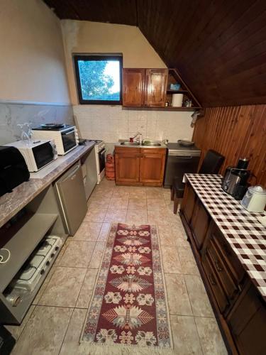 a small kitchen with a rug on the floor at Meandri Ćehotine in Pljevlja
