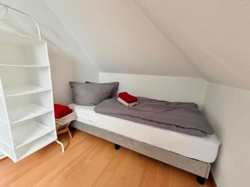 a bedroom with a bed and a book shelf at Moderne Wohnung in der Heide in Winsen
