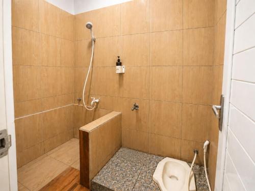 a bathroom with a shower with a toilet in it at New Dgyp Ciater Resort in Ciater
