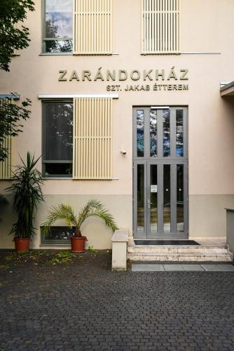 a building with a door and plants in front of it at Mátraverebély-Szentkút Nemzeti Kegyhely in Mátraverebély