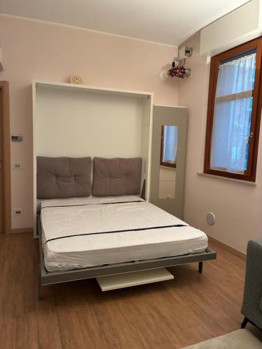 a large bed in a room with a bed frame at Il Glicine in Cusano Milanino