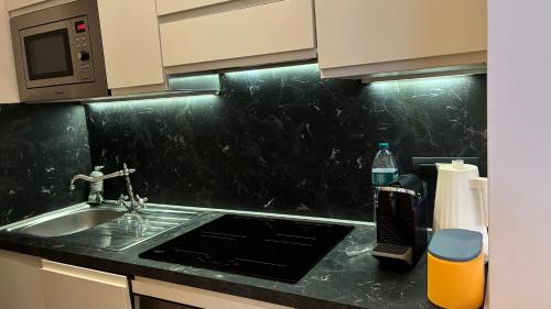a kitchen counter with a sink and a microwave at Il Glicine in Cusano Milanino
