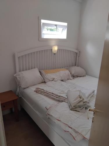 a bed with white sheets and pillows in a room at Gästrum in Halmstad