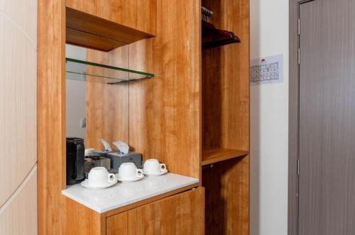 a kitchen with a counter with cups and a sink at Triton Exotica in Maafushi