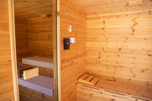 a wooden sauna with two bunk beds in it at Hárs Fogadó in Ötvös