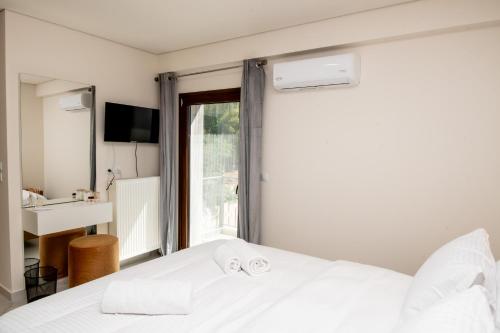 a bedroom with a white bed and a sink at Ligiades 945 in Ligiades