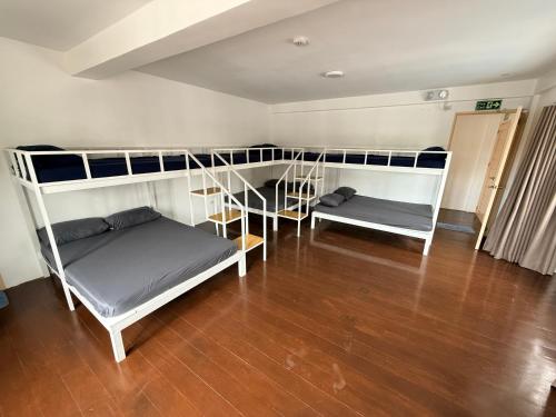 a room with two bunk beds and a wooden floor at Casa Sakura 2 in Calamba
