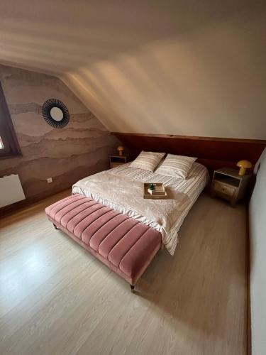 a bedroom with a bed in a attic at La Belle au Bois Joli in Raon-lʼÉtape