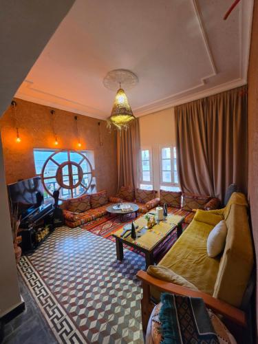 a living room with a couch and a table at CHÂTELET Ouarzazate in Tabount