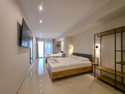 a bedroom with two beds in a room at Lucia Hotel Paralia in Paralia Katerinis