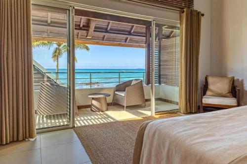 a bedroom with a view of the ocean at Villa Karma by muse villas in Grand-Baie