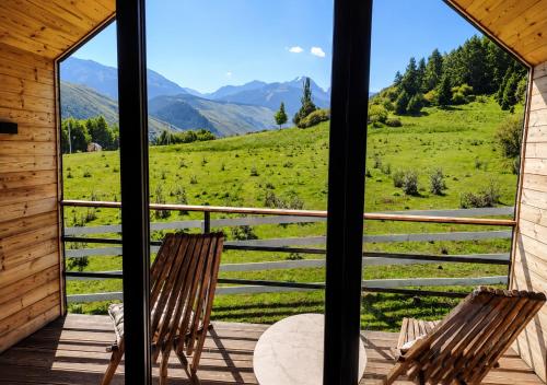 a view from the porch of a cabin with two chairs at Ayu Eco Hotel in Karakol