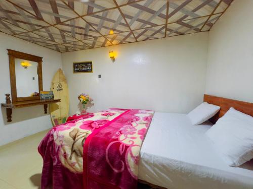 a bedroom with a bed with a red blanket on it at Sana's homestay haputhale in Haputale