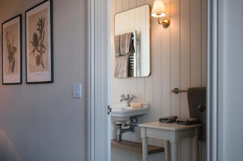 a bathroom with a sink and a mirror at Drumornie in Brora