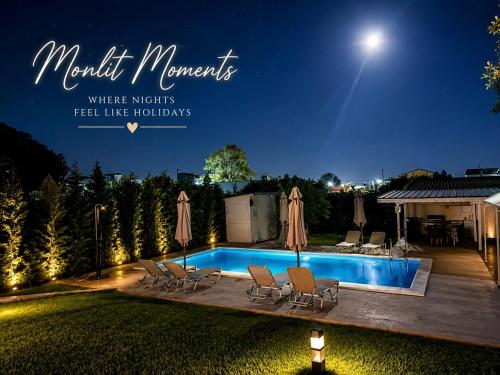 a backyard with a swimming pool at night at My House in Paralia Messi in Aroyí