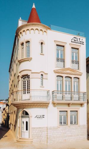 a large white building with a red roof at Alluz Nazare - Boutique Chalet By The Sea in Nazaré