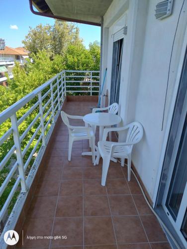 a balcony with a table and chairs on it at Catalina studios 2 in Olympic Beach