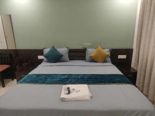 a bedroom with a bed with a remote control on it at FabHotels Divo in Chennai